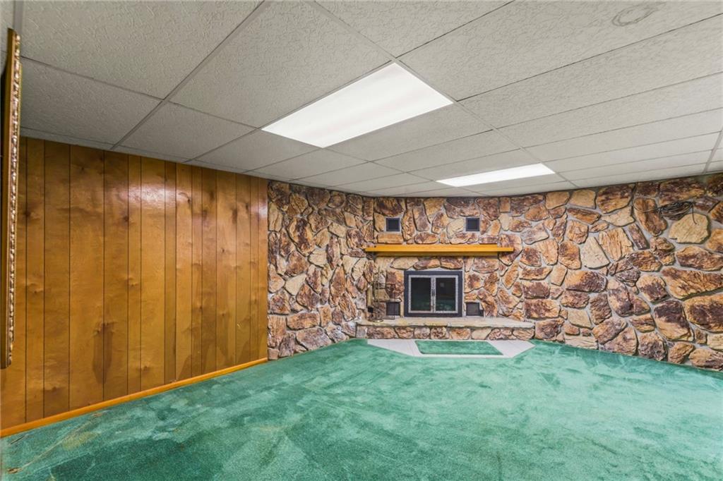 738 Beagle Club Road McDonald, PA 15057 - Photo 27 of 47 As we head downstairs to the finished basement, we are met with a HUGE gameroom and SECOND wood burning fireplace. So many possibilites for this space - play room? family room? teen hangout???