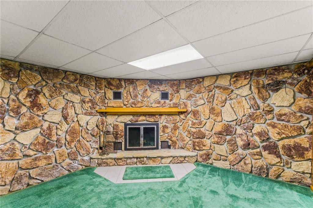 738 Beagle Club Road McDonald, PA 15057 - Photo 29 of 47 Whatever you decide to do with this room, please enjoy your second fireplace. Just like the one upstairs, it's embraced with this beautiful stone masonry wall.