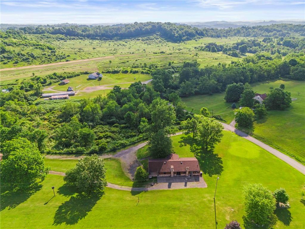 738 Beagle Club Road McDonald, PA 15057 - Photo 4 of 47 Enjoy the lush retreat of fresh green grass surrounding you. You get the best of both worlds here...mature trees and open space to let the sun shine through.