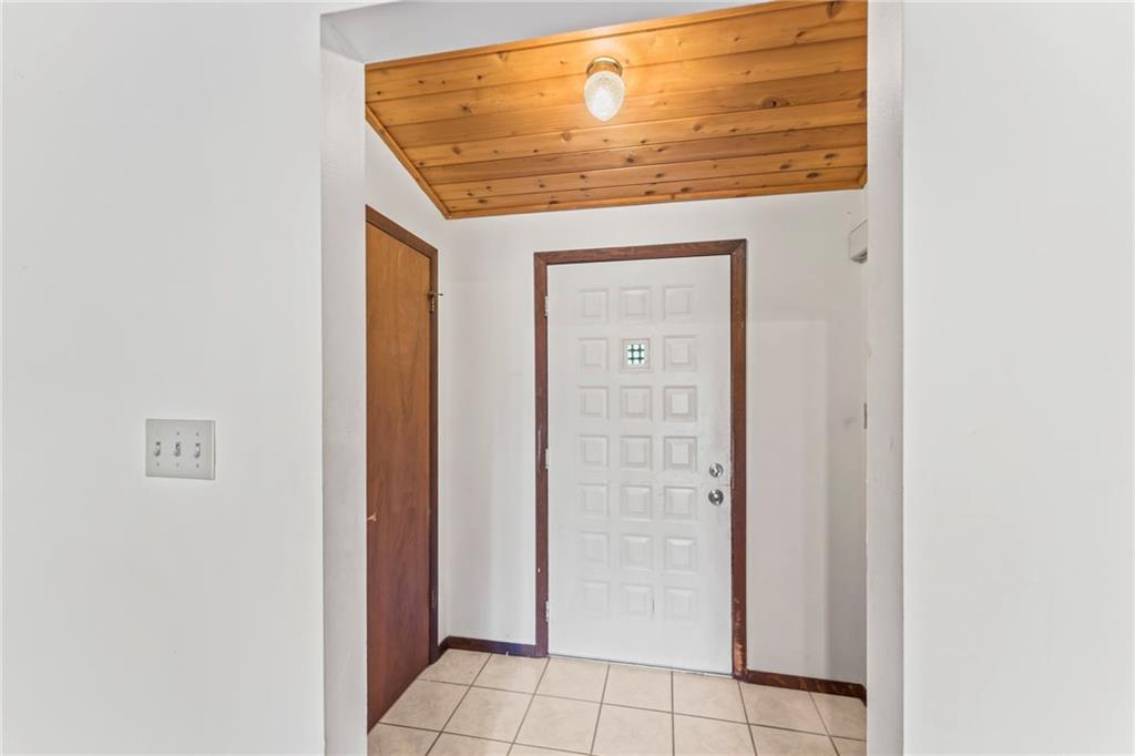 738 Beagle Club Road McDonald, PA 15057 - Photo 6 of 47 Step inside the foyer which houses a sizeable closet and entrace to the finished lower level. There's plenty of room for a shoe rack or small table to drop that mail. Oh.. and look up. The beautiful exposed cedar just gives that warm, 'Welcome Home' feeling.