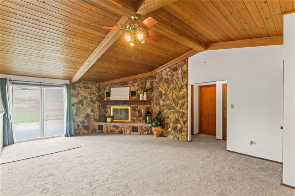 738 Beagle Club Road McDonald, PA 15057 - Photo 7 of 47 Once through the foyer you are greeted with the sprawing 15' x 23' living room. The exposed cedar, vaulted ceiling coupled with the stone wall that houses the fireplace is the perfect balance of space and comfort. Plus the newer patio door (2016) lets in plenty of natural light.