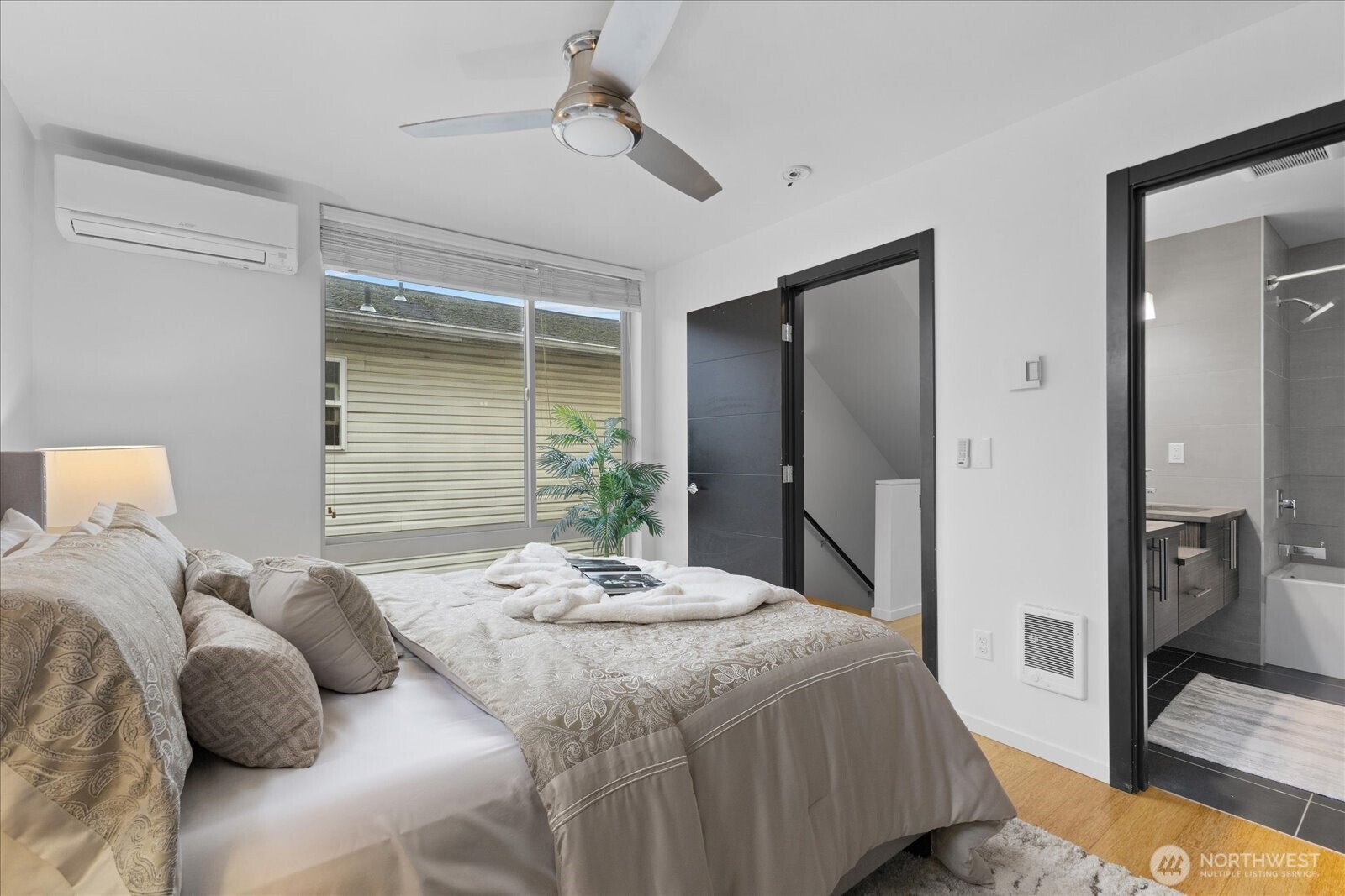 1525 Northwest 58th Street, Unit A Seattle, WA 98107 - Photo 13 of 24 a bedroom with a bed and a large mirror