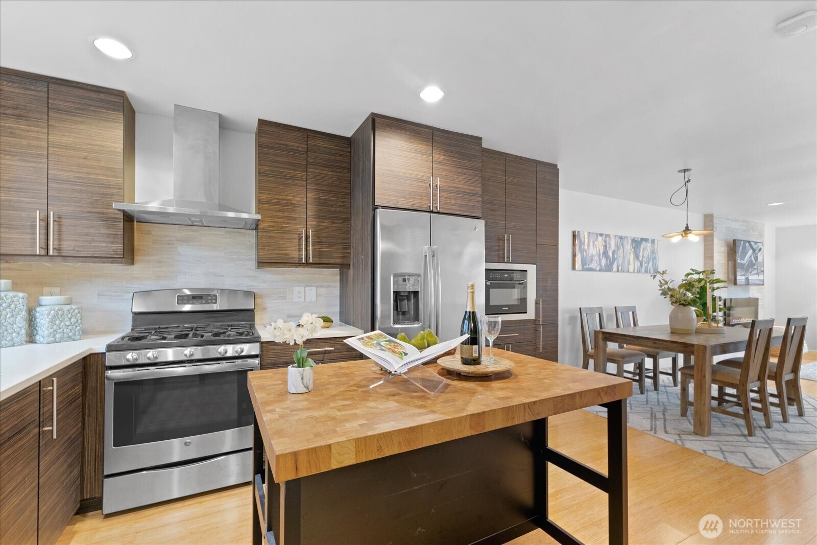 1525 Northwest 58th Street, Unit A Seattle, WA 98107 - Photo 6 of 24 a kitchen with a stove a table and chairs in it