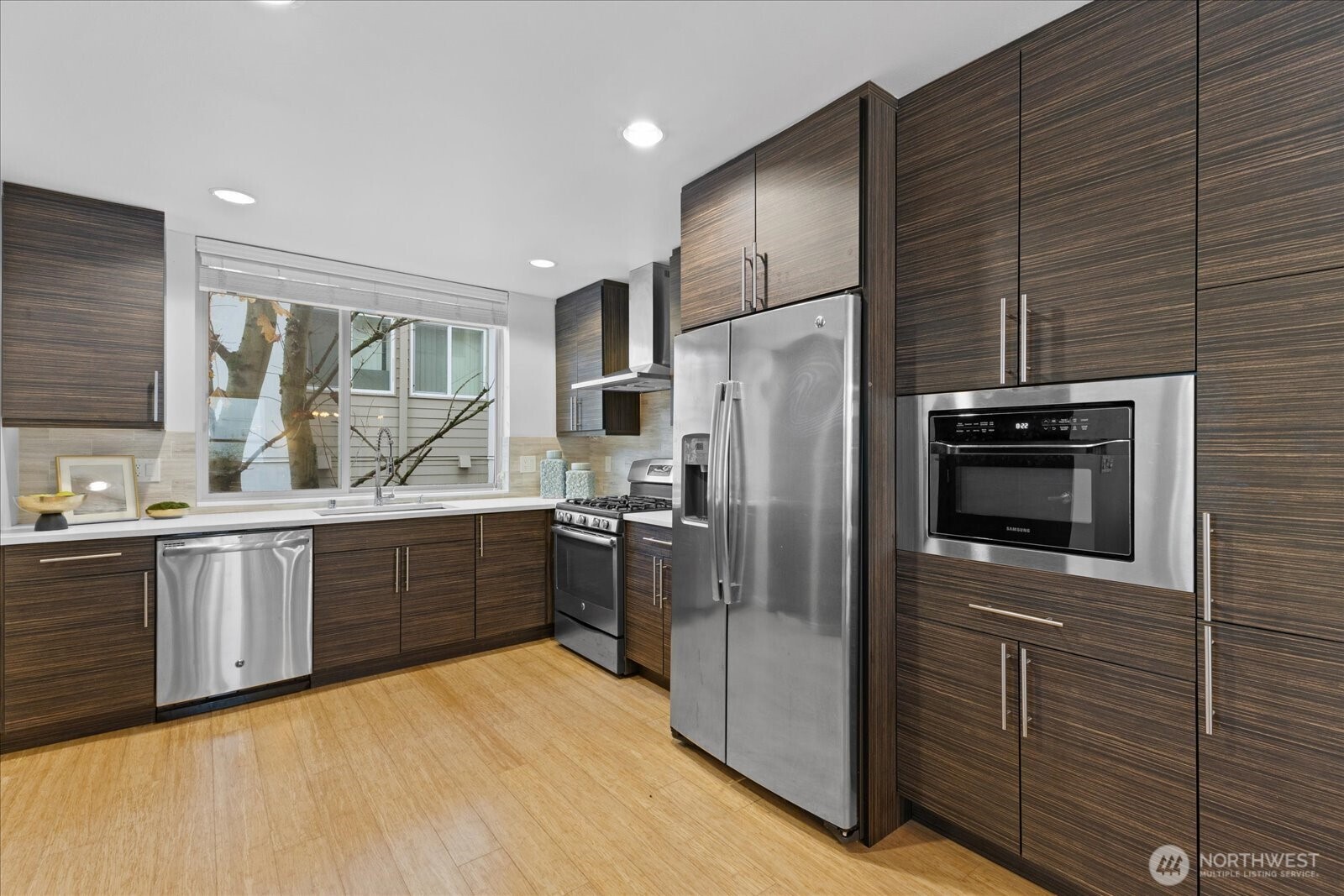 1525 Northwest 58th Street, Unit A Seattle, WA 98107 - Photo 8 of 24 a kitchen with stainless steel appliances a refrigerator and a sink