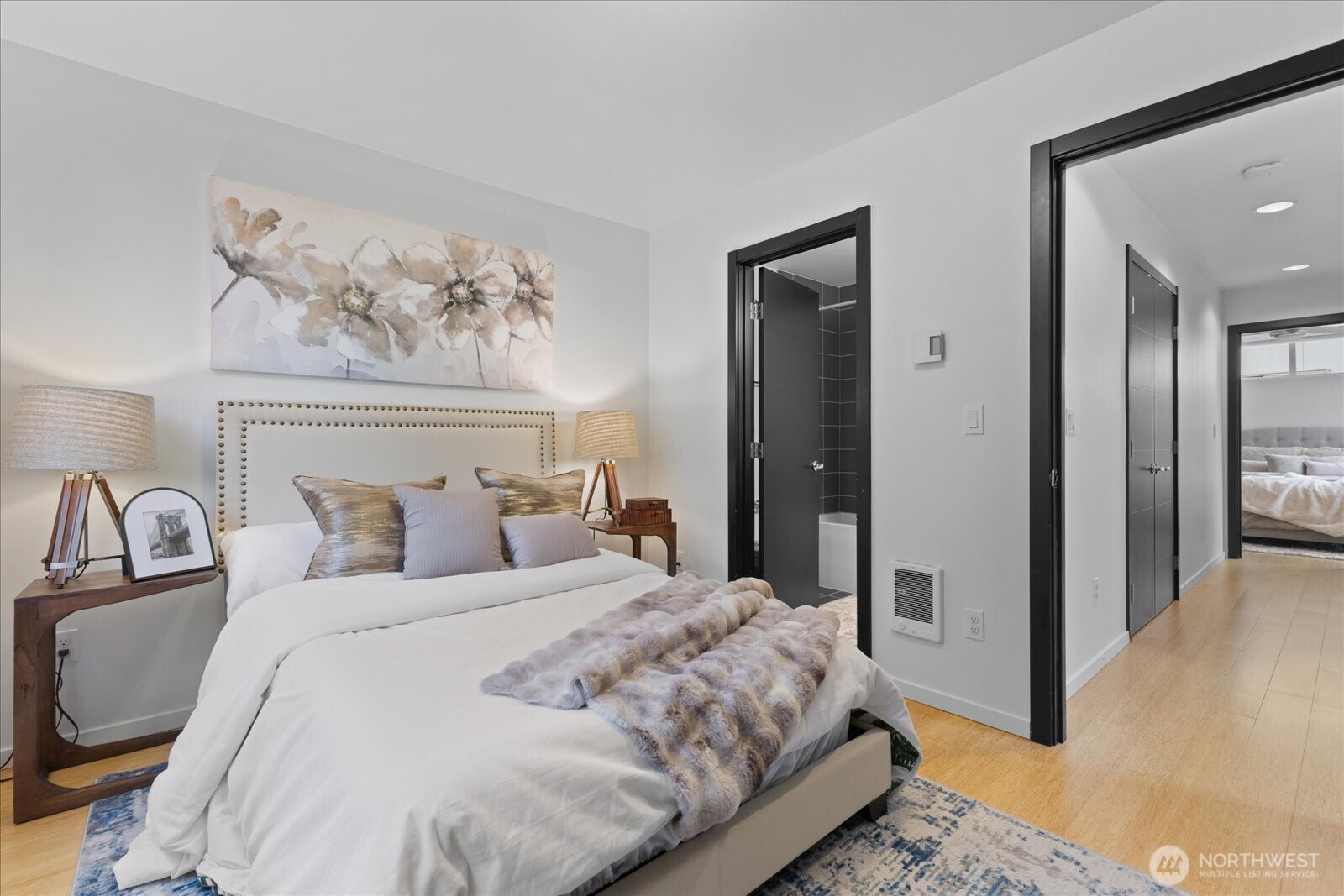 1525 Northwest 58th Street, Unit A Seattle, WA 98107 - Photo 9 of 24 a bedroom with a bed and a painting on the wall