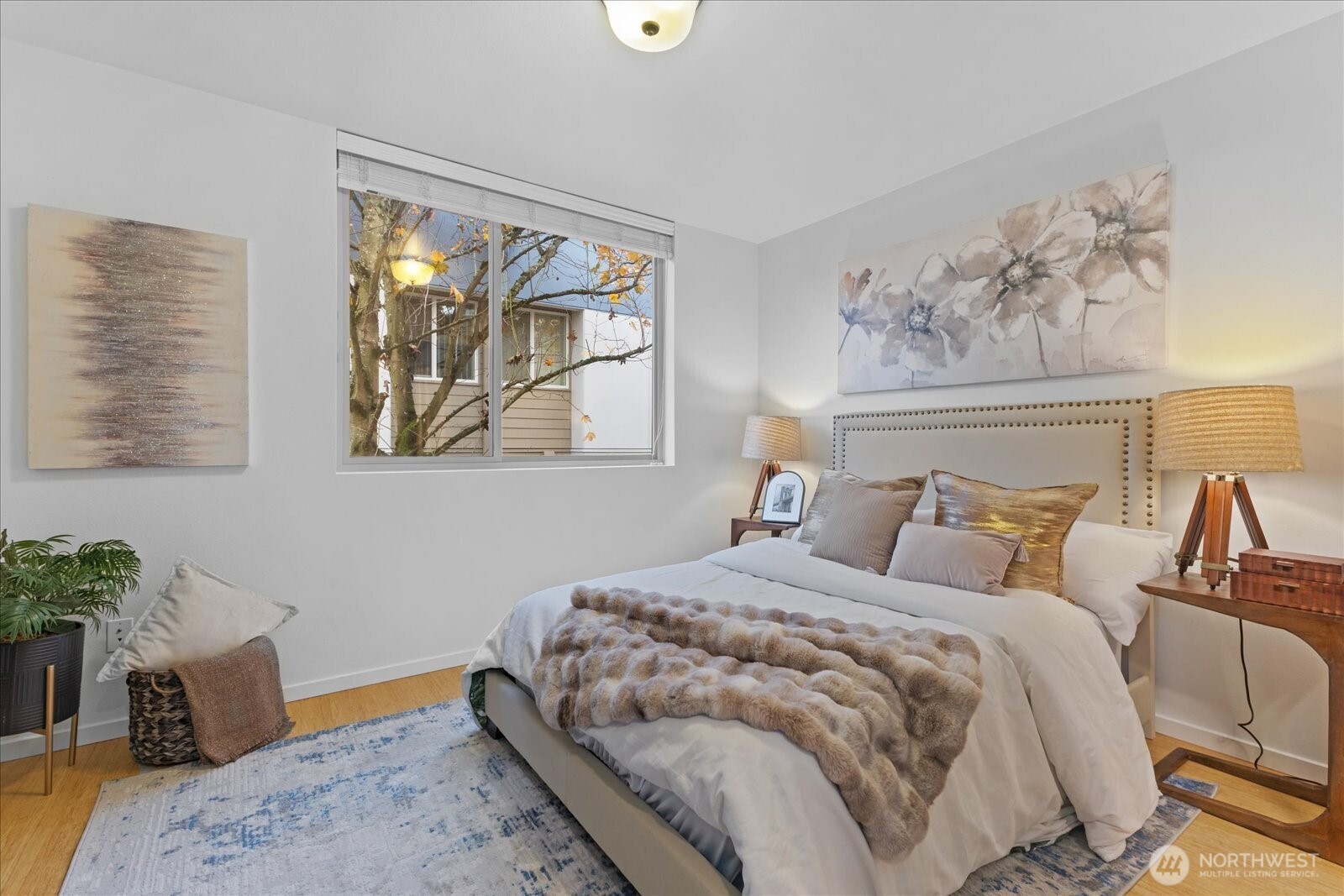 1525 Northwest 58th Street, Unit A Seattle, WA 98107 - Photo 10 of 24 a bedroom with a bed and wooden floor