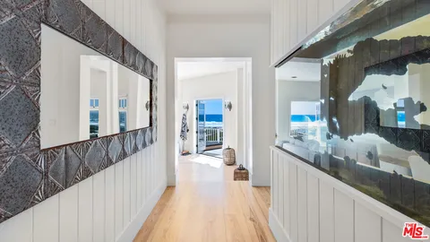 a living room with furniture a large window and a fireplace