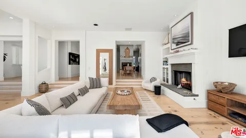 a view of a balcony with two chairs and a potted plant