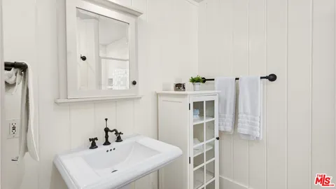a bathroom with a granite countertop sink and a bathtub