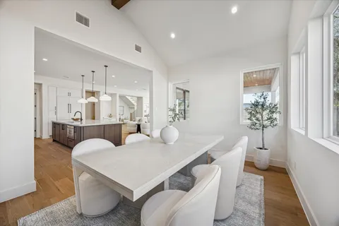 a living room with furniture a dining table and chairs