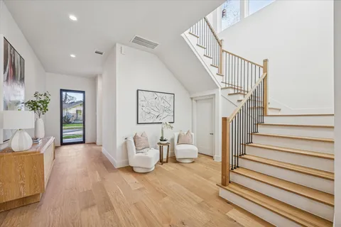 a view of entryway and hall with wooden floor