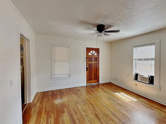wooden floor in an empty room with a window