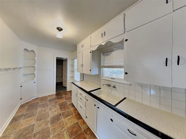 a spacious bathroom with a double vanity sink and a mirror