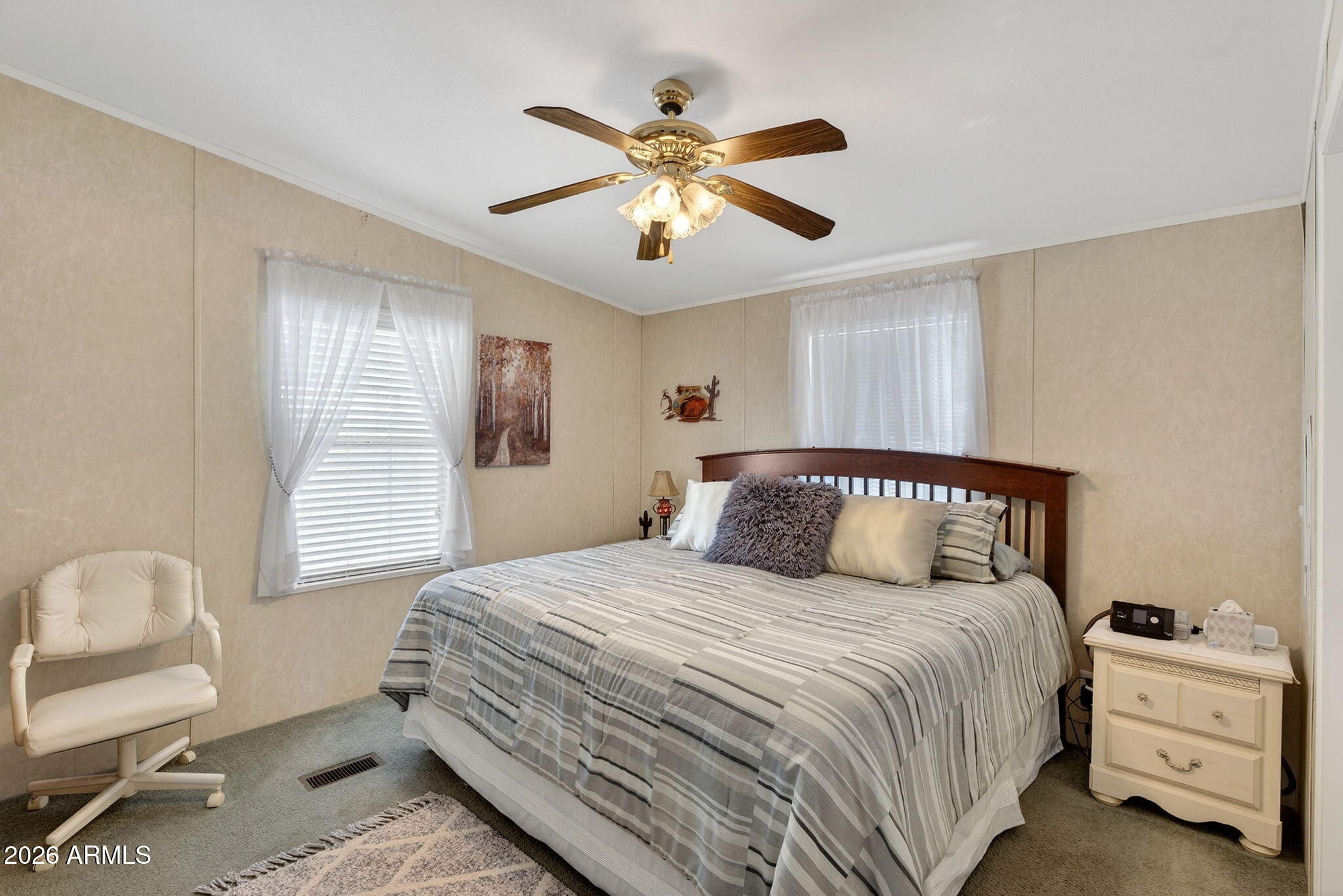 747 East Germann Road, Unit 54 San Tan Valley, AZ 85140 - Photo 10 of 26 a bedroom with a large bed and a chandelier