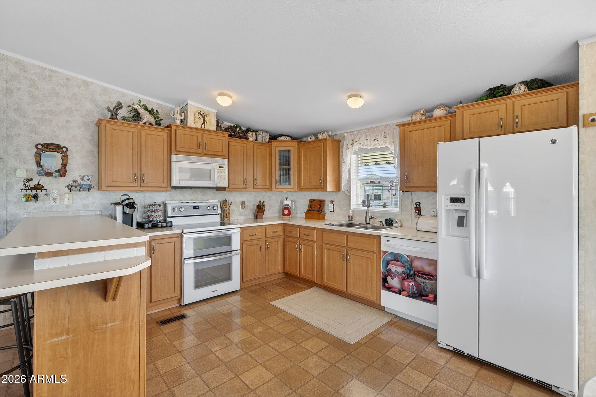 747 East Germann Road, Unit 54 San Tan Valley, AZ 85140 - Photo 5 of 26 a kitchen with a refrigerator a sink and cabinets