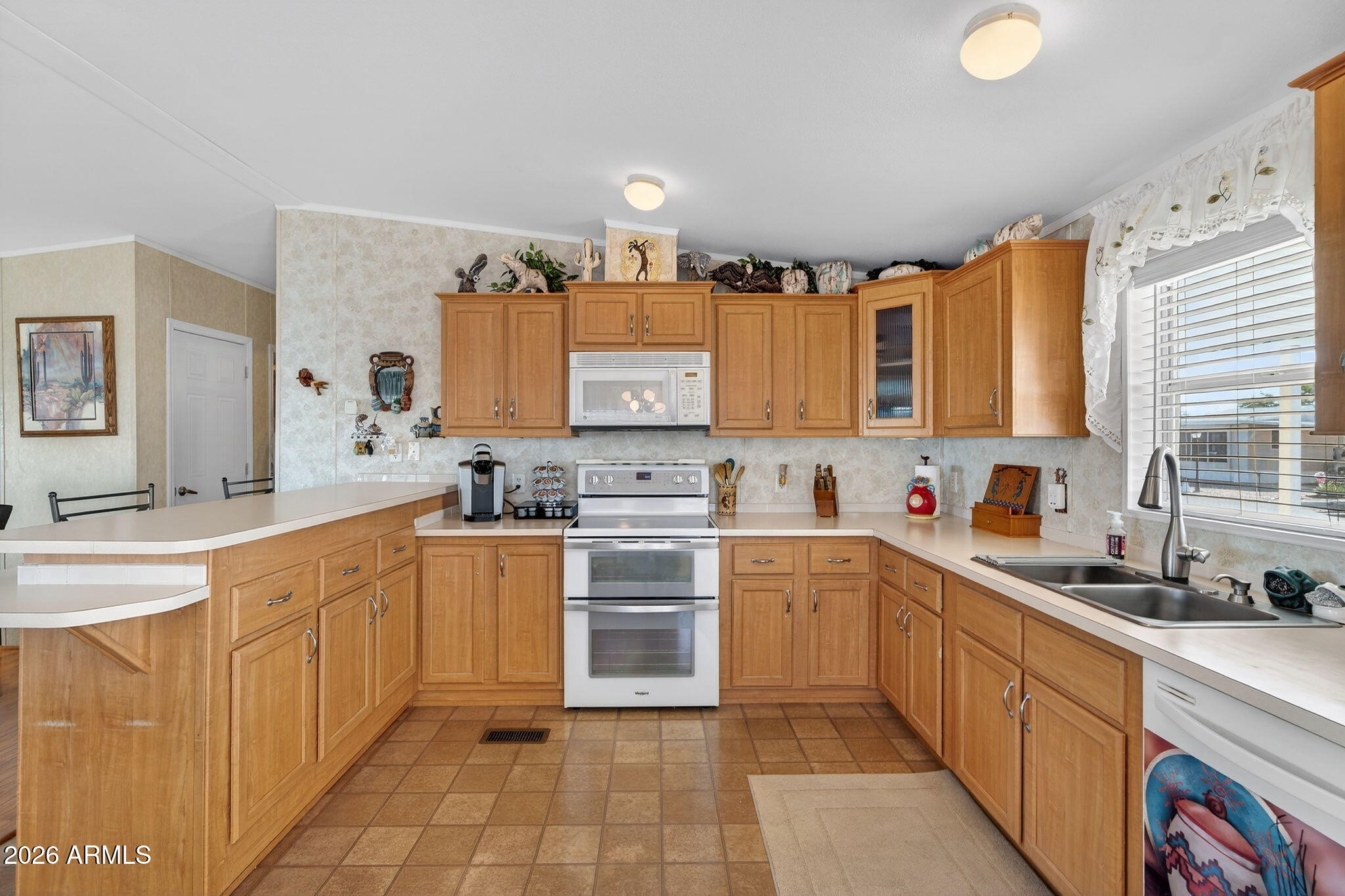 747 East Germann Road, Unit 54 San Tan Valley, AZ 85140 - Photo 6 of 26 a large kitchen with stainless steel appliances granite countertop a sink and cabinets