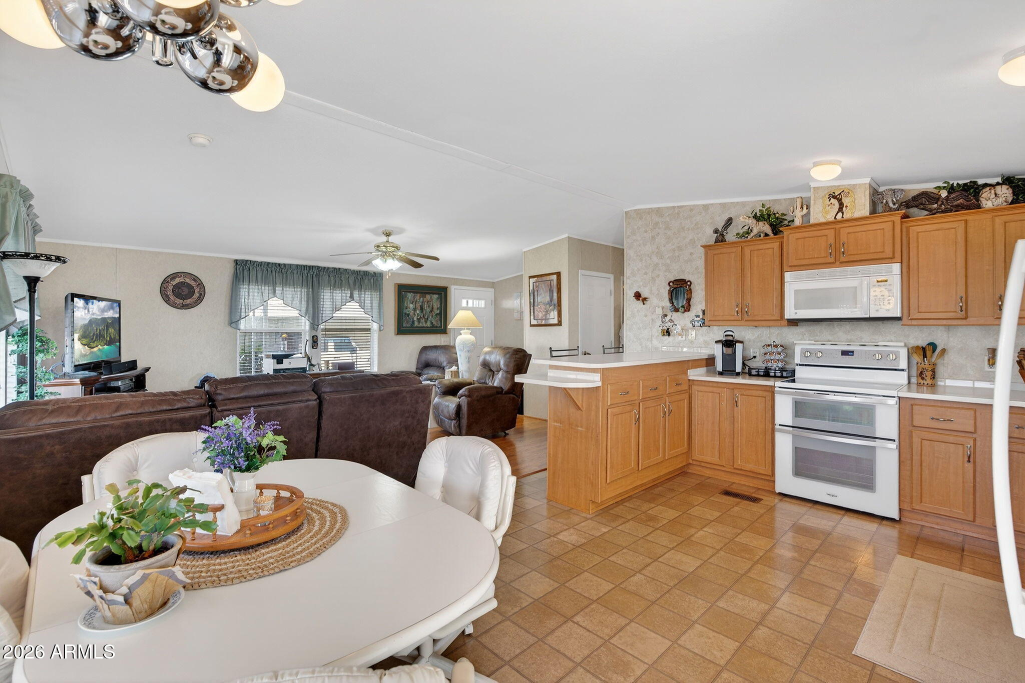 747 East Germann Road, Unit 54 San Tan Valley, AZ 85140 - Photo 9 of 26 a living room with furniture kitchen and a chandelier