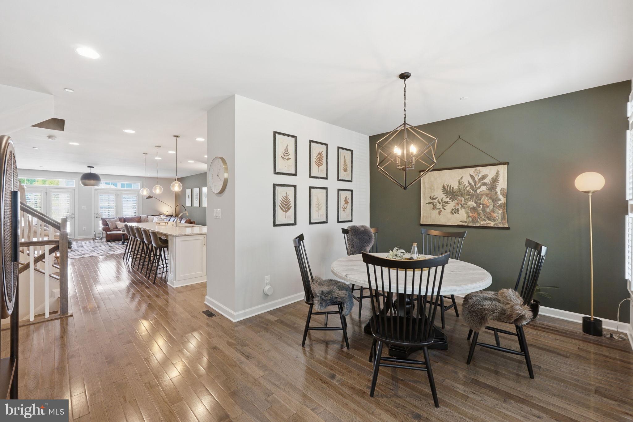 17812 Thomas Village Lane Sandy Spring, MD 20860 - Photo 14 of 37 a dining room with furniture a chandelier and wooden floor