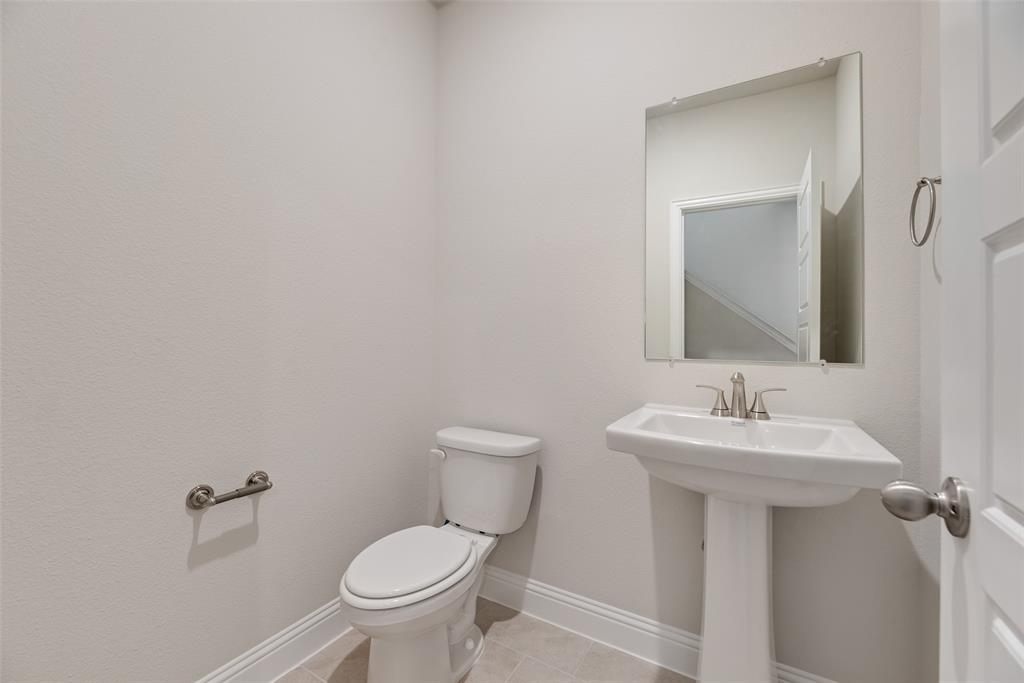 632 Marcus Lane Crowley, TX 76036 - Photo 26 of 34 a bathroom with a toilet sink and mirror