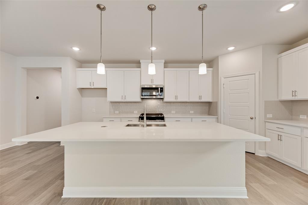 632 Marcus Lane Crowley, TX 76036 - Photo 5 of 34 a large kitchen with stainless steel appliances kitchen island a large island in the center
