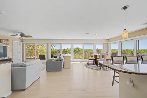 a living room with furniture and large windows