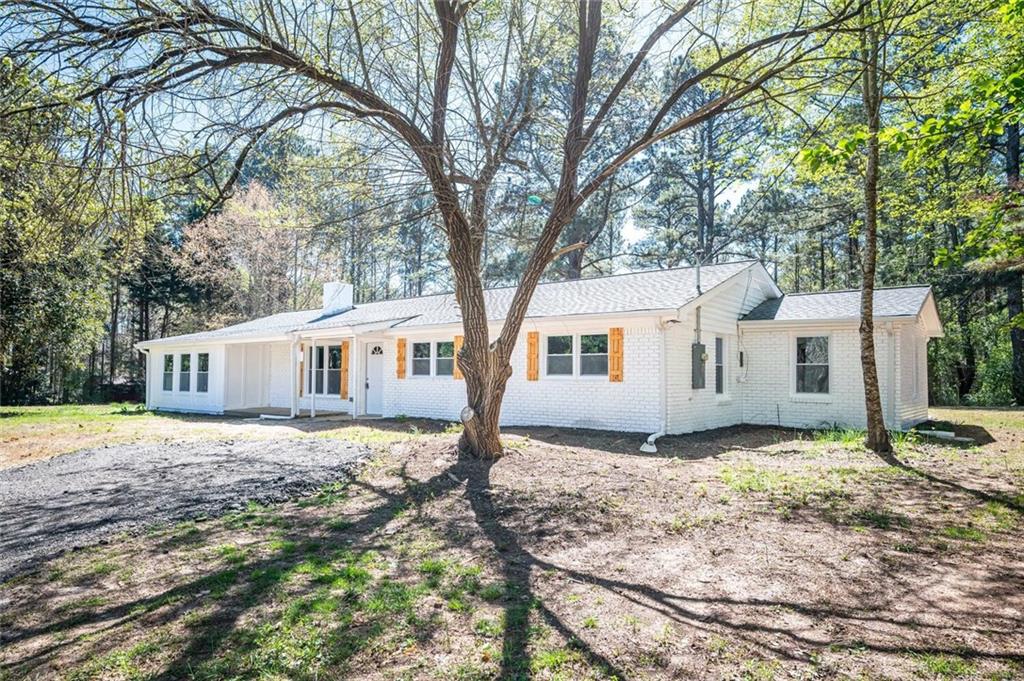 267 Miller Agan Road Temple, GA 30179 - Photo 1 of 1 a white house that has a tree in front of it