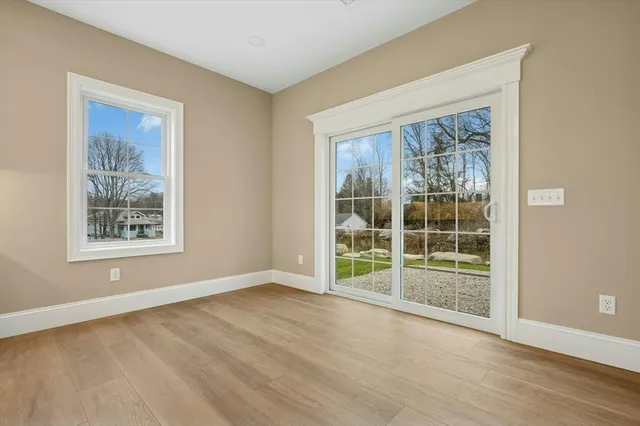 a view of a big room with wooden floor and windows