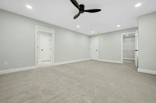 an empty room with projector and windows