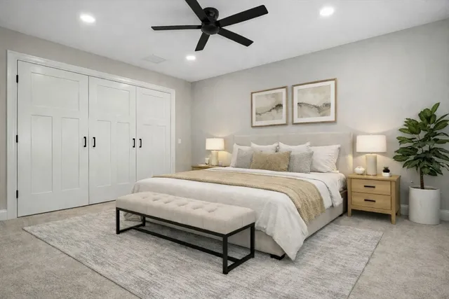 a spacious bedroom with a bed and a table