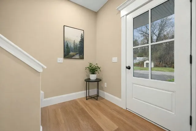 a view of a small space with wooden floor and a window