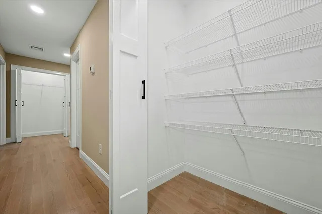 a view of a room with wooden floor