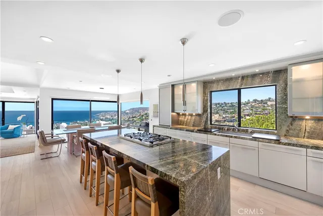 a kitchen with stainless steel appliances granite countertop sink stove and wooden cabinets