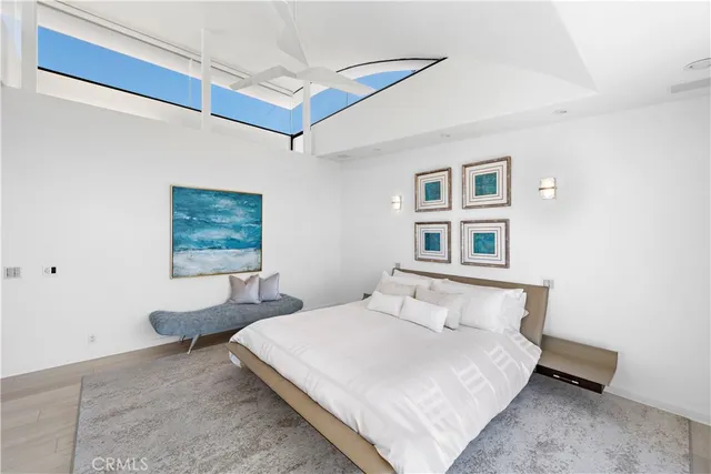 a bedroom with a large bed and a large window