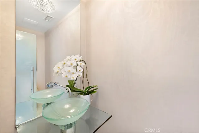 an outdoor living room with furniture and a floor to ceiling window