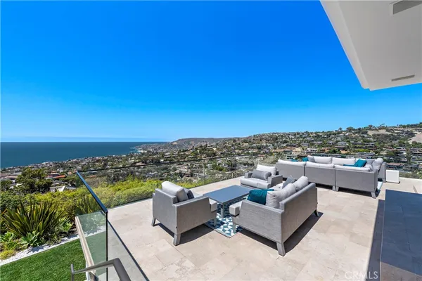 a view of roof deck with seating space and city view