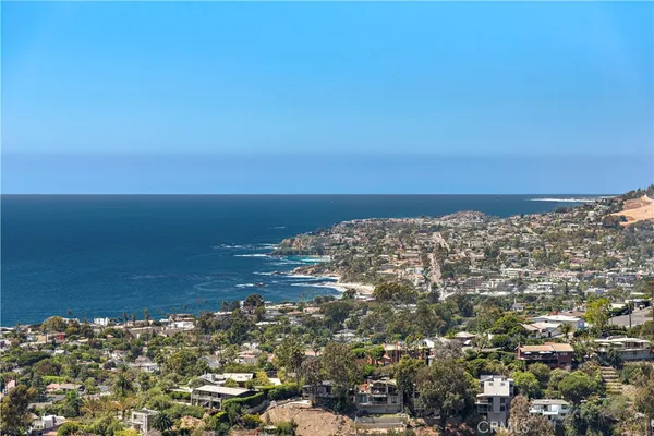 an outdoor living room with furniture and a floor to ceiling window