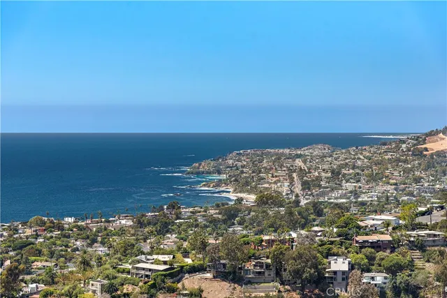 an outdoor living room with furniture and a floor to ceiling window