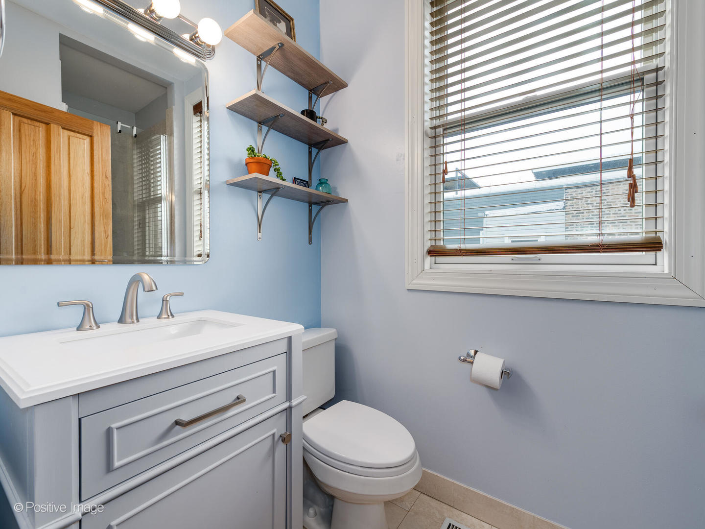2039 West Rice Street, Unit 3 Chicago, IL 60622 - Photo 12 of 18 a bathroom with a toilet sink and mirror