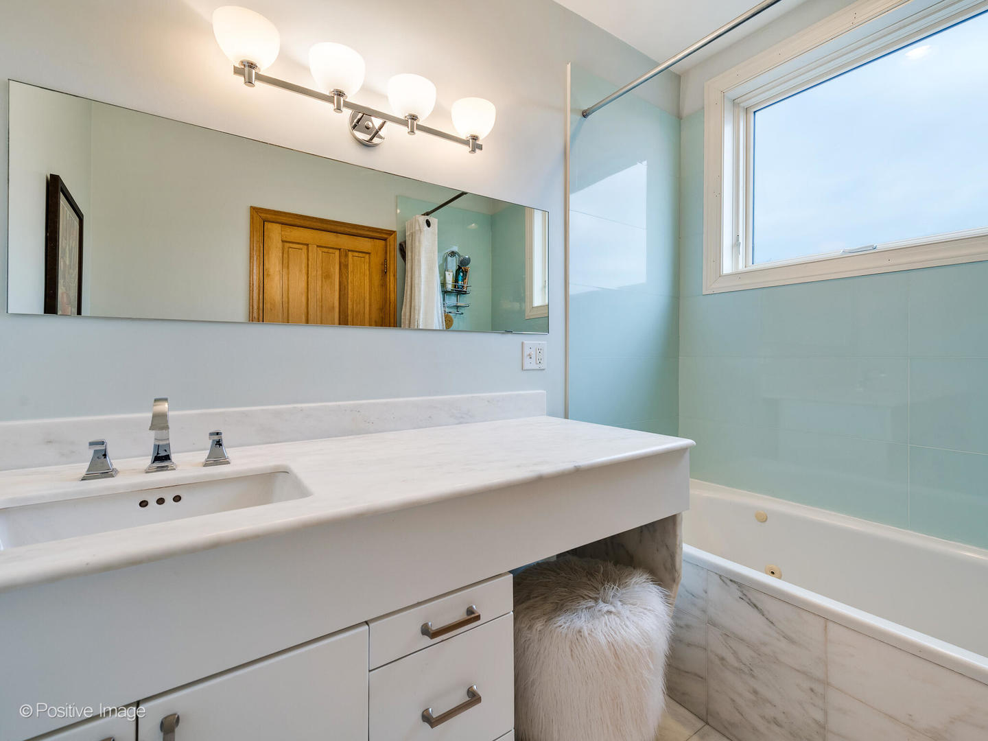 2039 West Rice Street, Unit 3 Chicago, IL 60622 - Photo 15 of 18 a bathroom with a sink a mirror and a bathtub