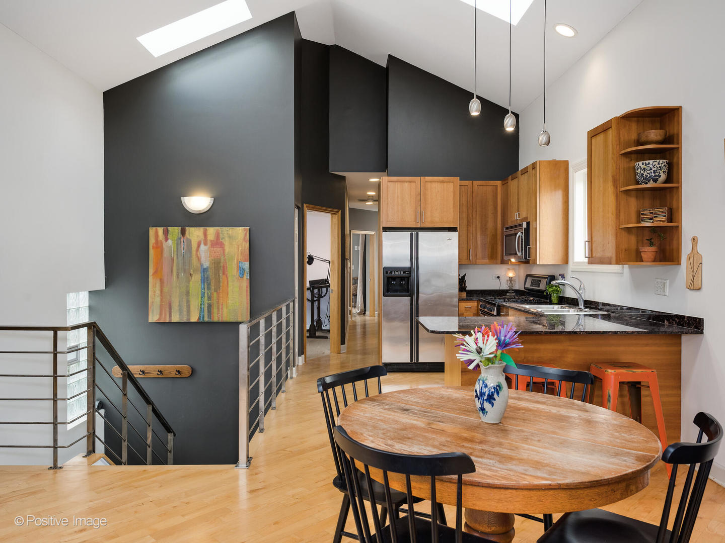 2039 West Rice Street, Unit 3 Chicago, IL 60622 - Photo 6 of 18 a kitchen with stainless steel appliances kitchen island granite countertop a table chairs in it and wooden floors