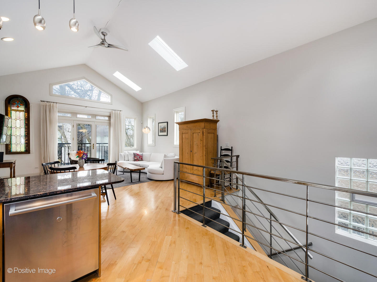 2039 West Rice Street, Unit 3 Chicago, IL 60622 - Photo 9 of 18 a living room with couches a dining table and chairs with chandelier