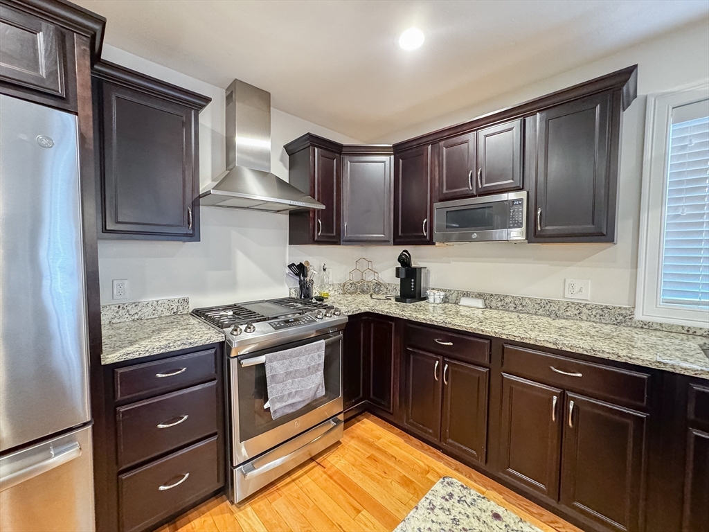 23 Ralph Street Chicopee, MA 01020 - Photo 5 of 42 a kitchen with a stove sink and cabinets