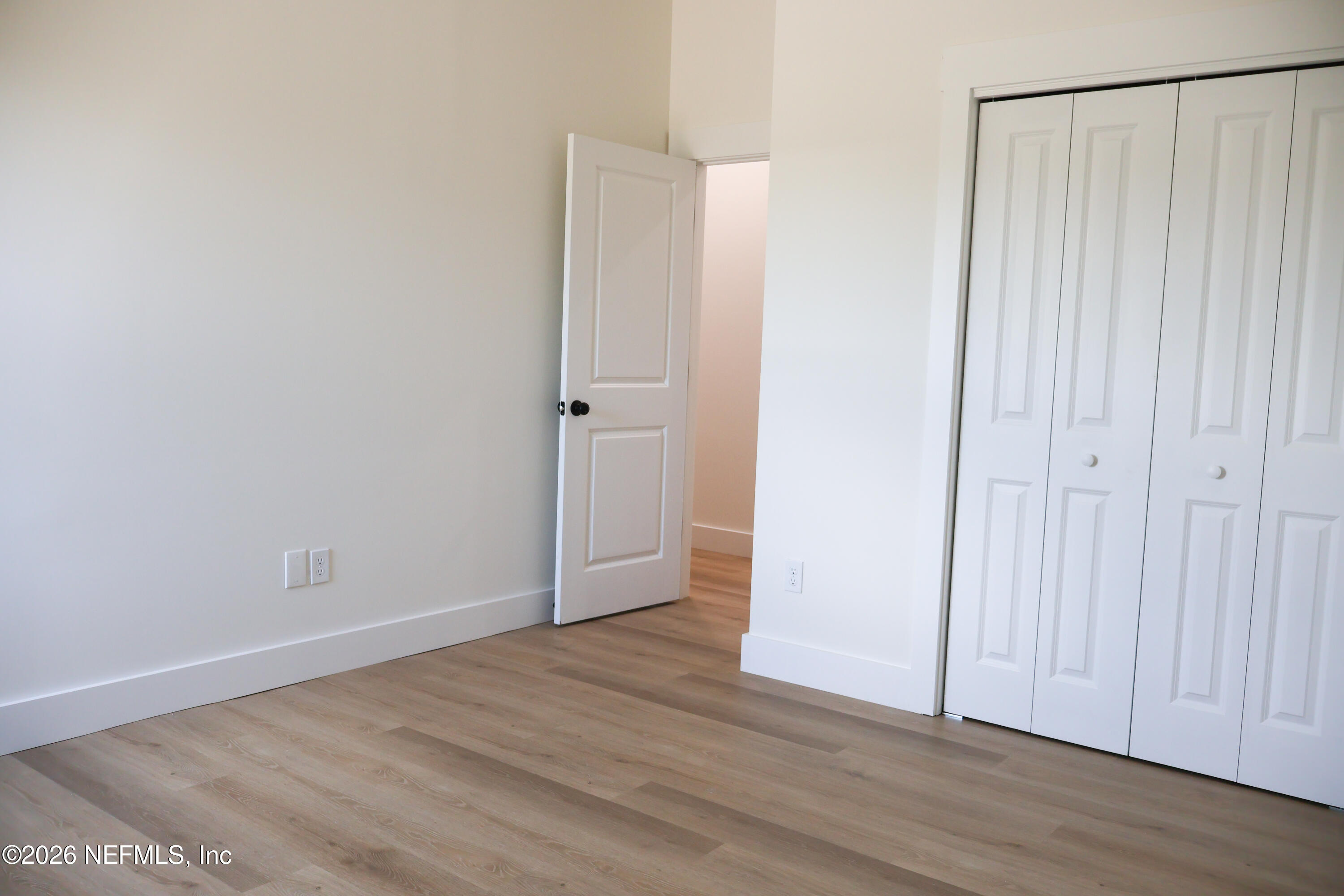 261121 Rowe Road Hilliard, FL 32046 - Photo 23 of 33 a view of an empty room with wooden floor