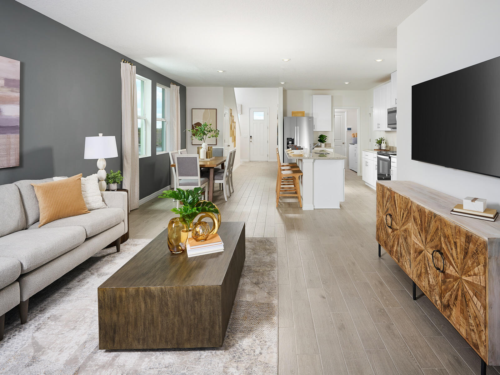 14320 Southwest New Dawn Road Indiantown, FL 34956 - Photo 4 of 9 a living room with furniture kitchen view and a flat screen tv