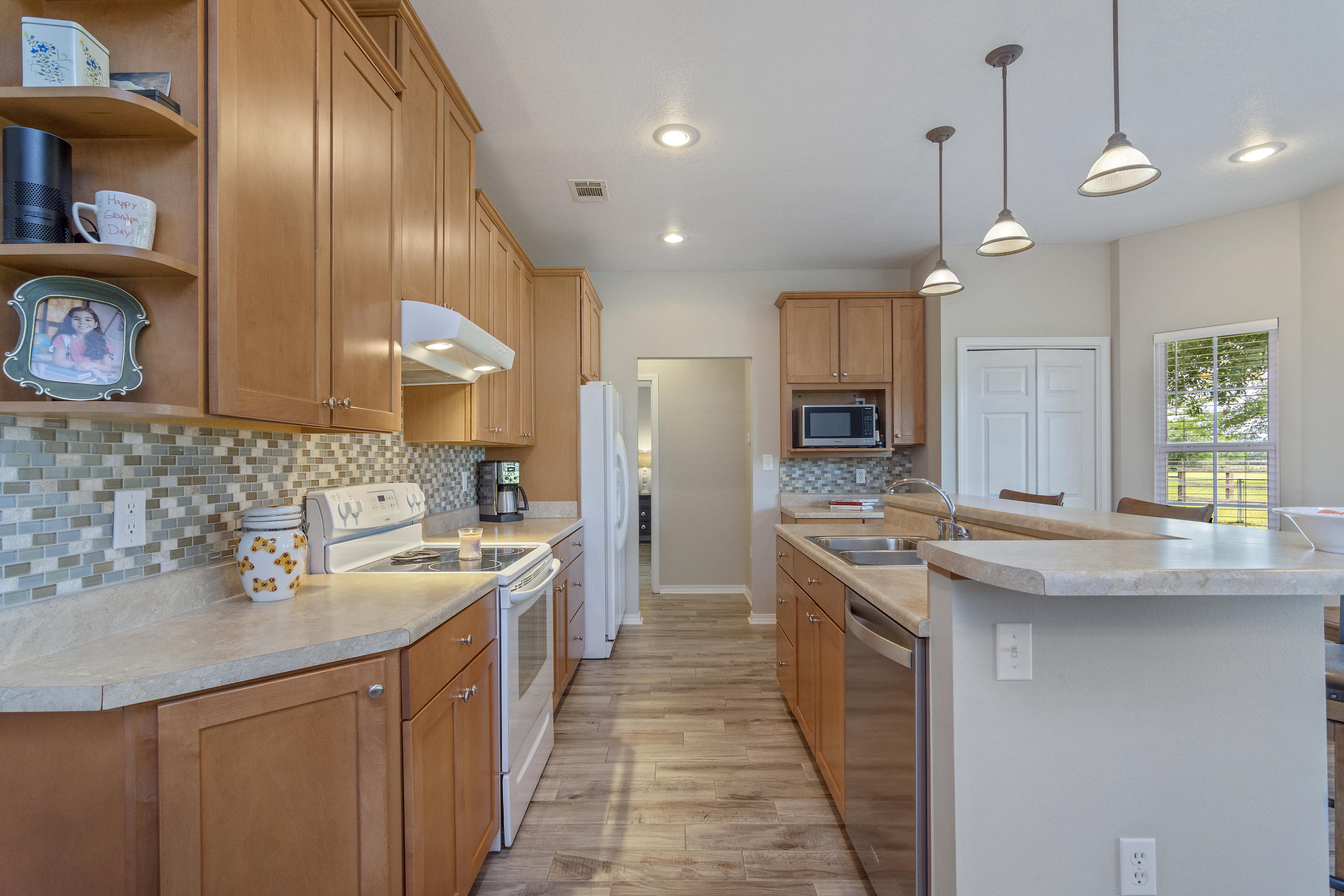 5780 Griffith Mill Road Baker, FL 32531 - Photo 12 of 50 a kitchen with stainless steel appliances granite countertop a sink a stove and a refrigerator