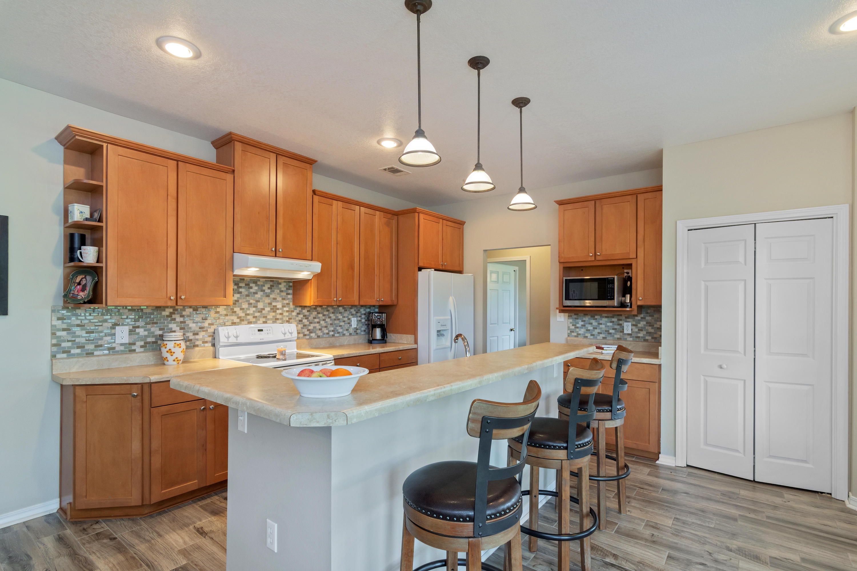 5780 Griffith Mill Road Baker, FL 32531 - Photo 14 of 50 a kitchen with granite countertop a stove a sink a dining table and chairs