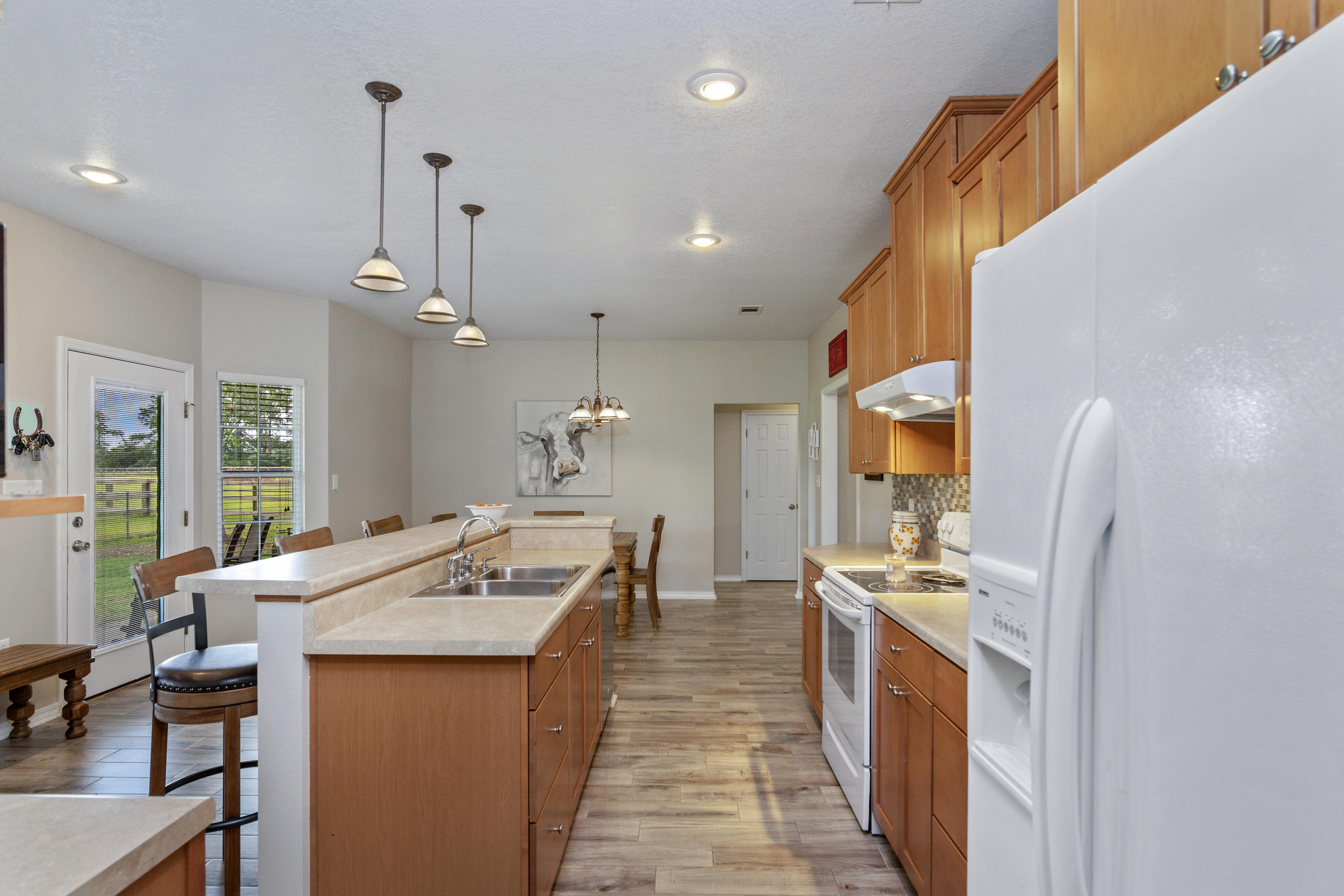5780 Griffith Mill Road Baker, FL 32531 - Photo 17 of 50 a large kitchen with a counter top space a sink stainless steel appliances and cabinets