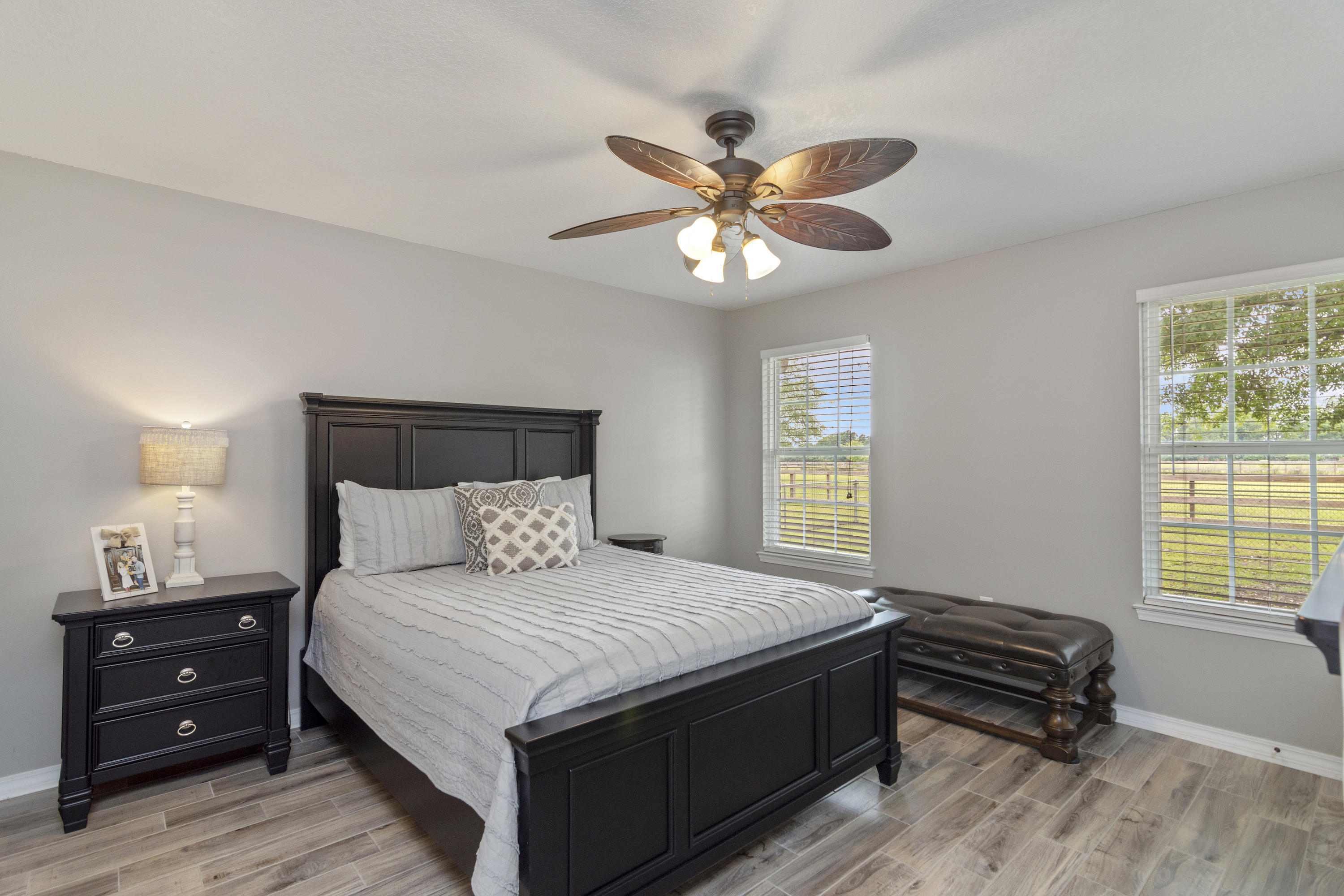 5780 Griffith Mill Road Baker, FL 32531 - Photo 18 of 50 a bedroom with a bed and a chandelier