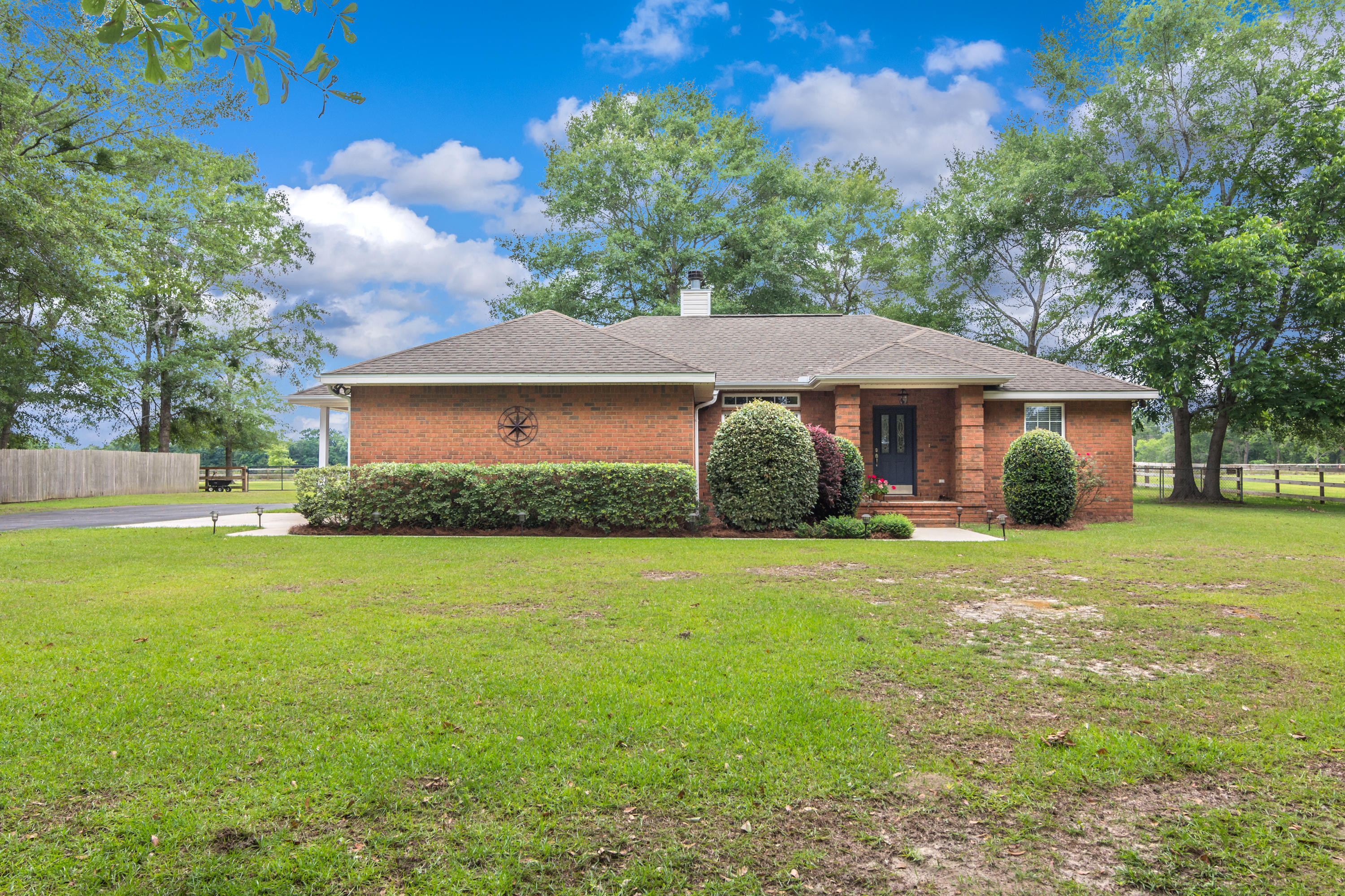5780 Griffith Mill Road Baker, FL 32531 - Photo 3 of 50 a front view of a house with a garden