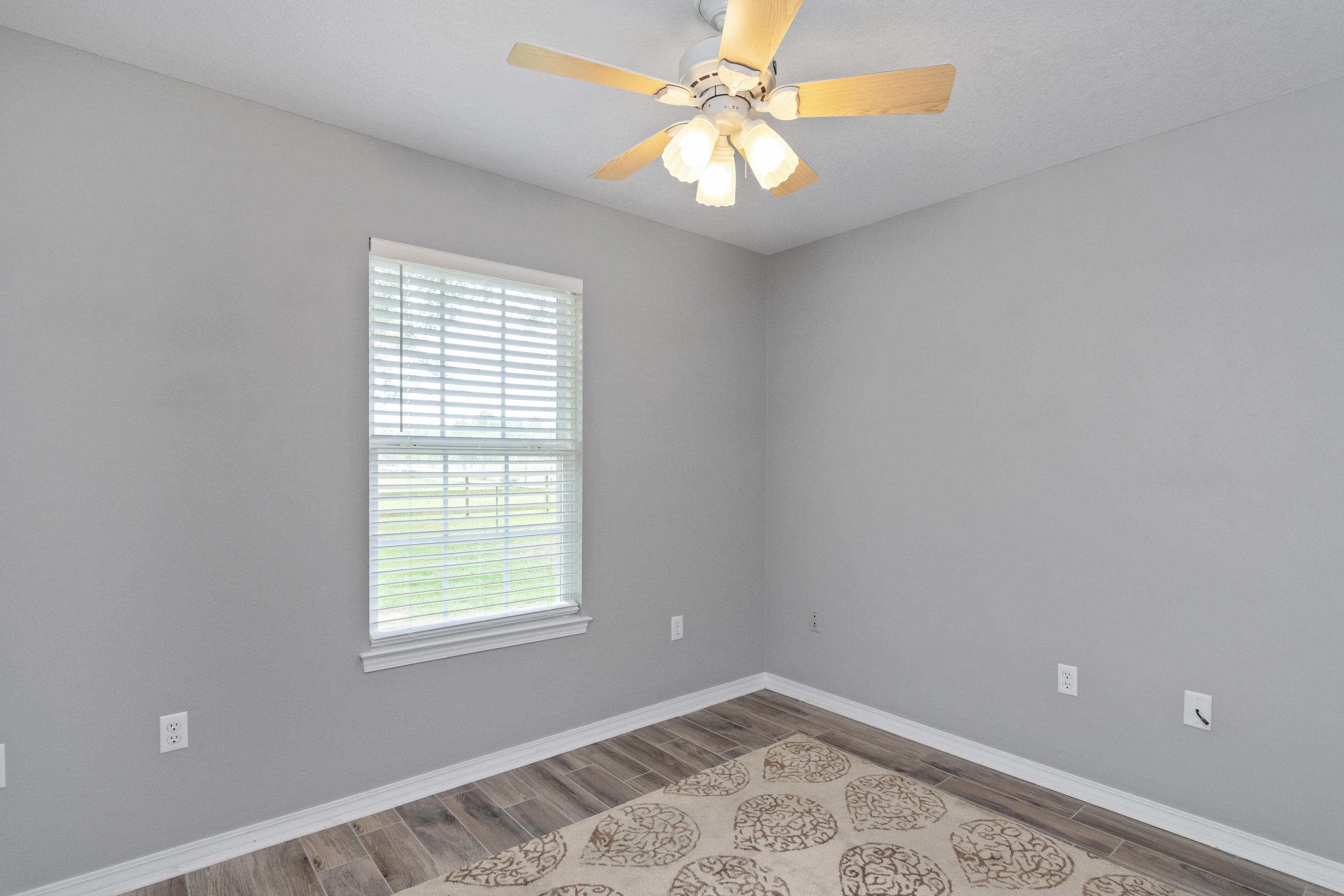 5780 Griffith Mill Road Baker, FL 32531 - Photo 26 of 50 a view of a big room with windows and chandelier fan